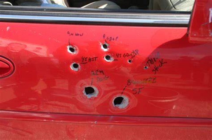 A Bullet Hole Penetrating A Cafe Window