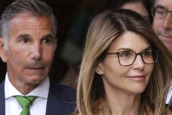 Actress Lori Loughlin, front, and husband, clothing designer Mossimo Giannulli, left, depart federal court in Boston on Wednesday, April 3, 2019, after facing charges in a nationwide college admissions bribery scandal. (AP Photo/Steven Senne)