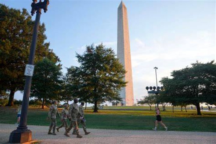 DC National Guard walk around the Capitol grounds, Thursday morning, Jan. 7, 2021 in Washington. The House and Senate certified the Democrat's electoral college win early Thursday after a violent throng of pro-Trump rioters spent hours Wednesday running rampant through the Capitol. A woman was fatally shot, windows were bashed and the mob forced shaken lawmakers and aides to flee the building, shielded by Capitol Police. (AP Photo/Julio Cortez)