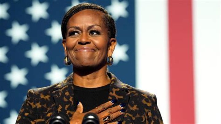 Former first lady Michelle Obama stands next to her official White House portrait during a ceremony in the East Room of the White House, in Washington. The former first lady chose artist Sharon Sprung to do her portrait Biden Obama Portraits, Washington, United States - 07 Sep 2022