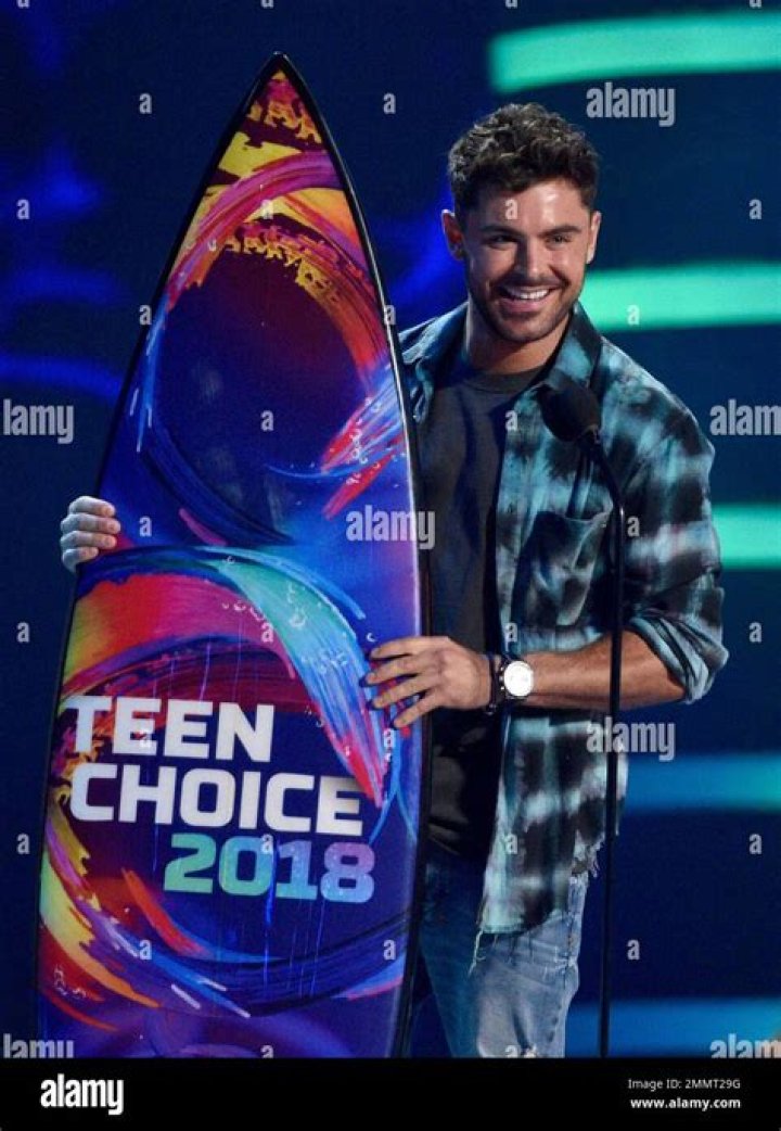 Zac Efron accepts the award for best shirtless performance for That Awkward Moment on stage at the MTV Movie Awards, at Nokia Theatre in Los Angeles 2014 MTV Movie Awards - Show, Los Angeles, USA - 13 Apr 2014